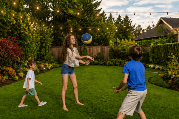 Family enjoying a green backyard with fewer mosquitoes